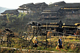 Local Wooden Houses of the Eastern Zhuang minority. Note the girls in foreground bringing the harvest home
