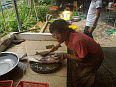 Image: Au San's wife preparing a live fish 02 - Click to Enlarge